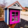 Charming Little Free Library pink door and house-like design invites community book sharing