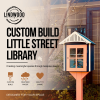 Custom-built little street library with coral door and navy blue roof, displayed in garden setting — Lindwood handcrafted design