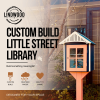 Custom-built little street library with coral door and navy blue roof, displayed in garden setting — Lindwood handcrafted design
